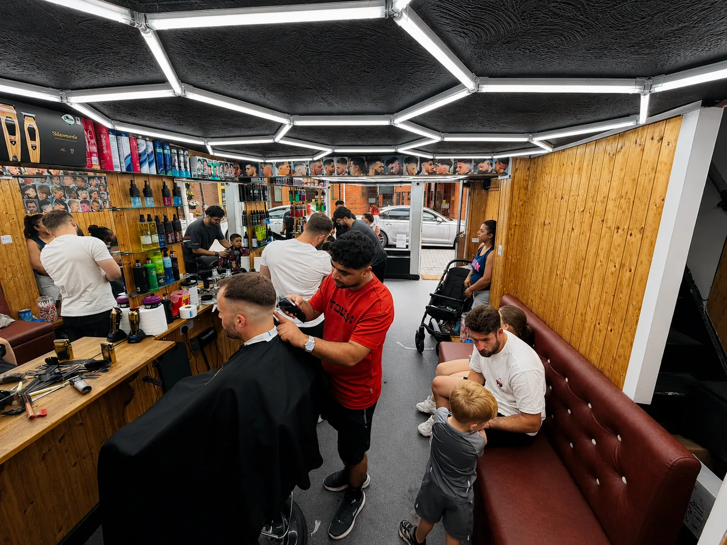 Barber cutting a client's hair inside Gentz Cutz