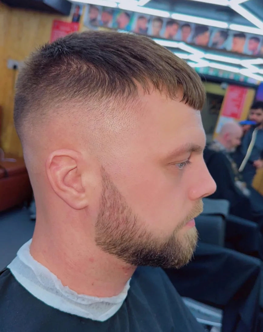 Close-up of a sharp fade with a shaped full beard