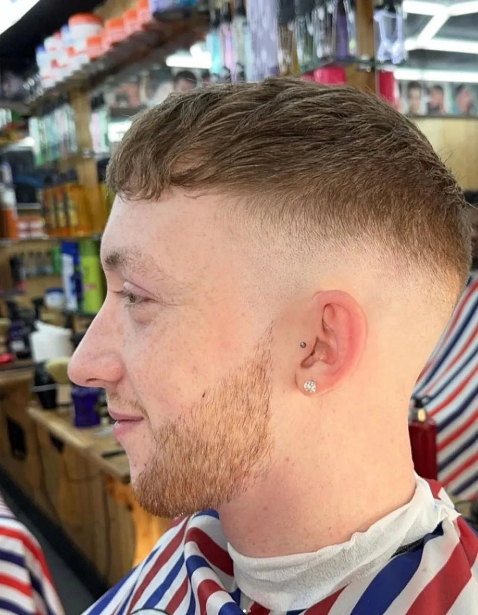 Close-up of a clean low fade and shaped beard