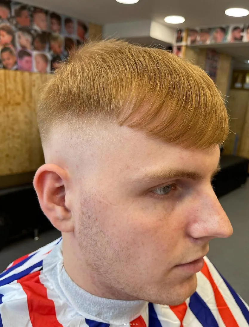 Close-up of a high skin fade with a textured ginger fringe