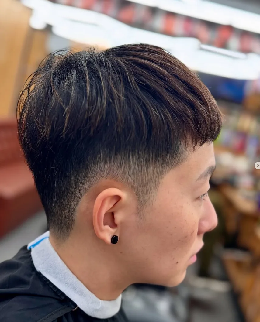 Close-up of a modern textured haircut with faded sides