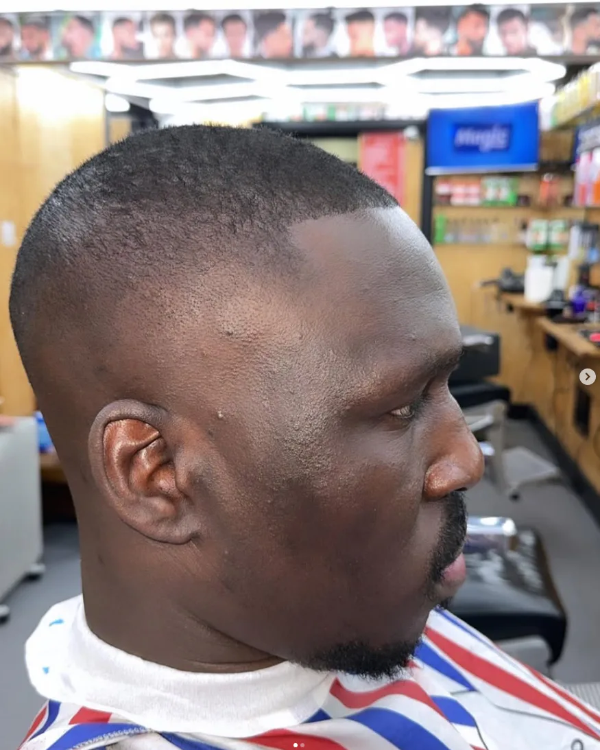 Close-up of a clean short fade with a shaped goatee