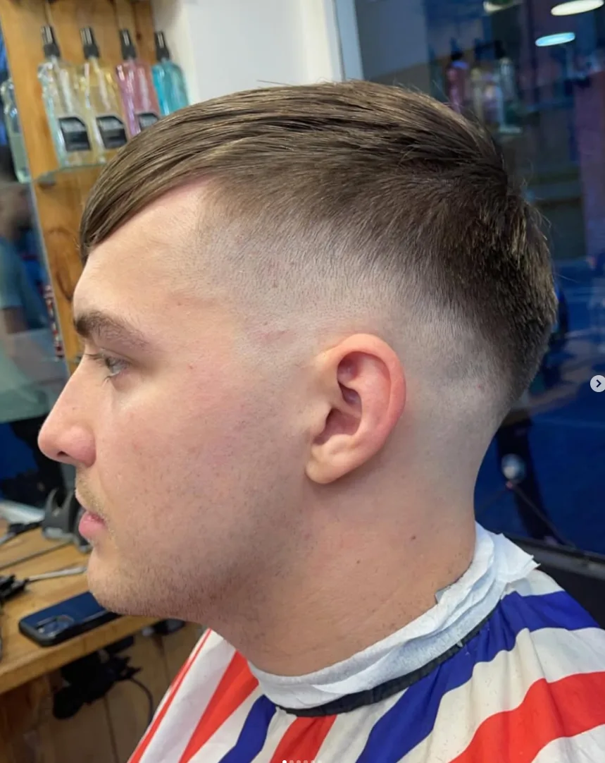 Close-up of a skin fade with a side-swept top